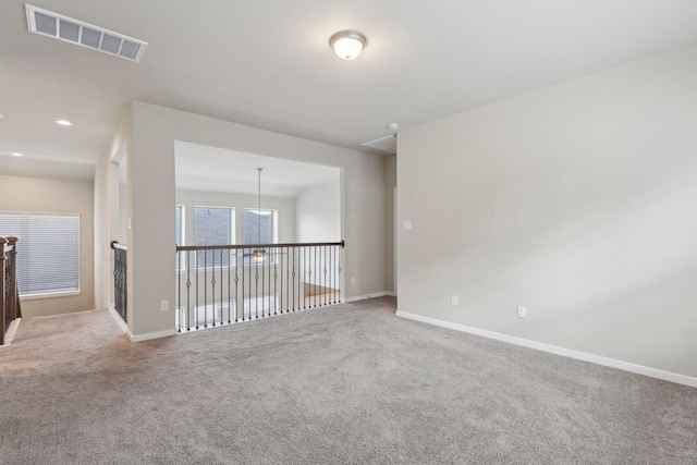 empty room featuring recessed lighting, baseboards, visible vents, and carpet flooring