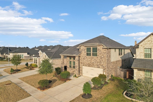 view of front facade with driveway, a garage, a residential view, and brick siding