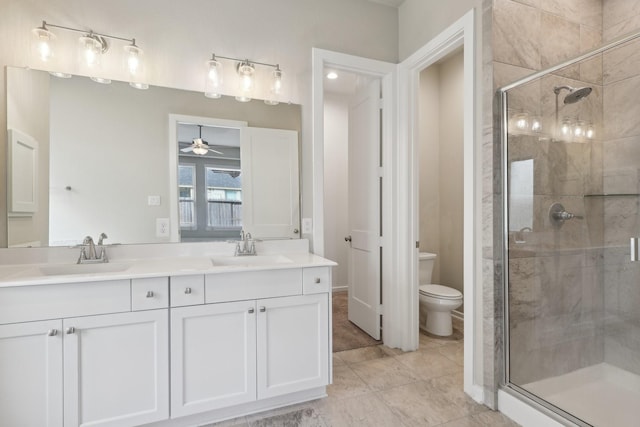 full bathroom featuring toilet, double vanity, and a sink