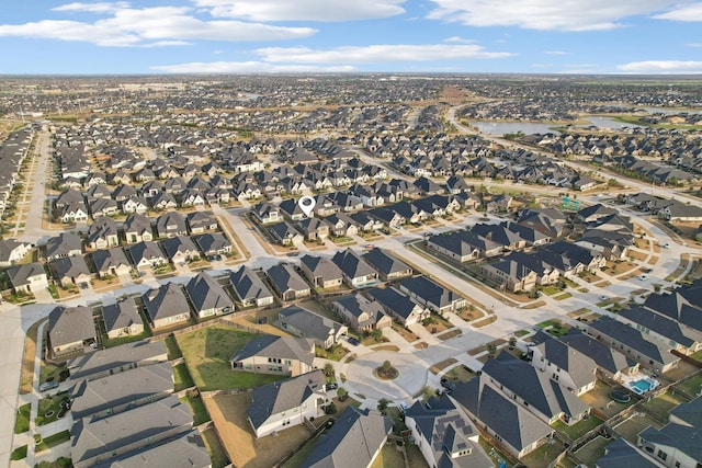 drone / aerial view with a residential view and a water view