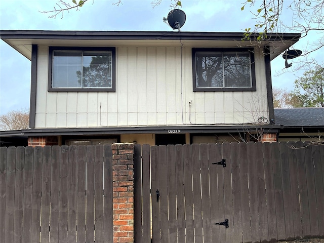 view of side of home featuring fence