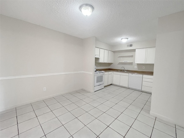 kitchen featuring white appliances, a sink, visible vents, white cabinetry, and open shelves