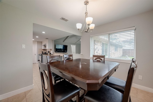 dining area featuring light tile patterned floors, baseboards, visible vents, and an inviting chandelier