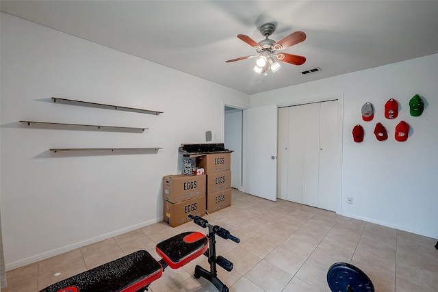 exercise room with light tile patterned floors, a ceiling fan, visible vents, and baseboards