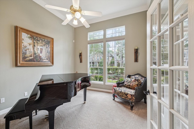 carpeted home office featuring a ceiling fan, baseboards, and crown molding