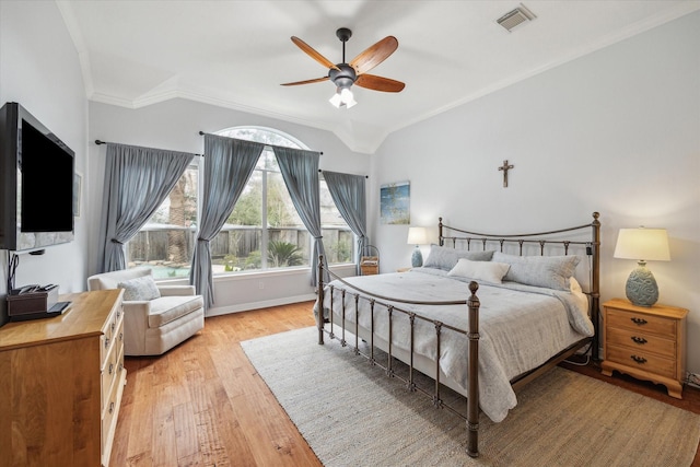 bedroom with visible vents, baseboards, a ceiling fan, crown molding, and light wood-style floors