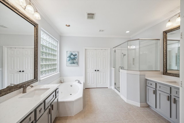 bathroom with a sink, a stall shower, two vanities, and visible vents