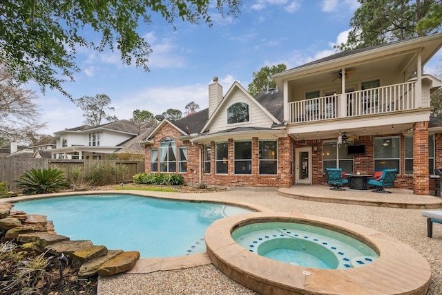 view of pool featuring an in ground hot tub, a patio, fence, and a ceiling fan