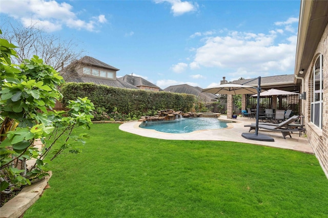view of pool featuring a fenced in pool, a patio area, fence private yard, and a lawn