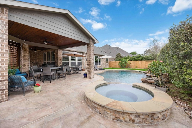 view of pool featuring a fenced in pool, an in ground hot tub, a ceiling fan, a patio area, and fence