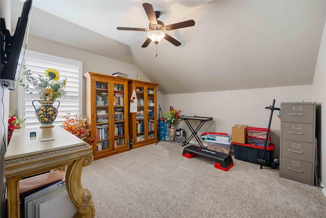 interior space featuring ceiling fan, carpet, and vaulted ceiling