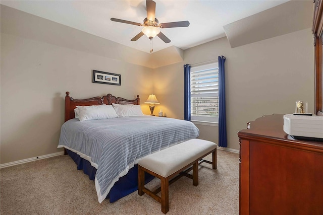 bedroom featuring baseboards, ceiling fan, and light carpet