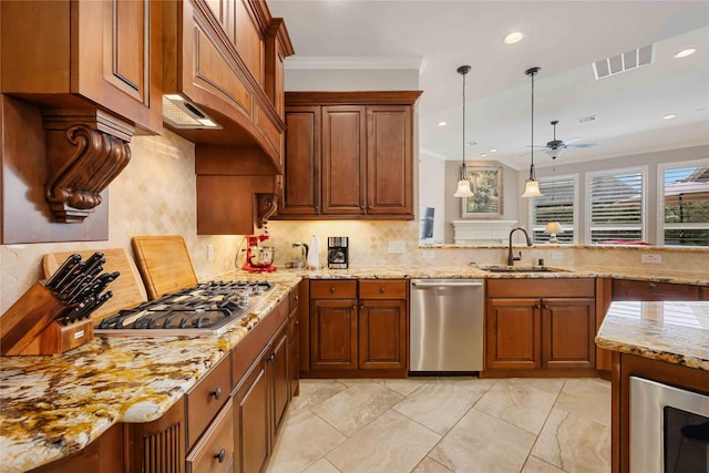 kitchen featuring a ceiling fan, visible vents, brown cabinetry, appliances with stainless steel finishes, and a sink