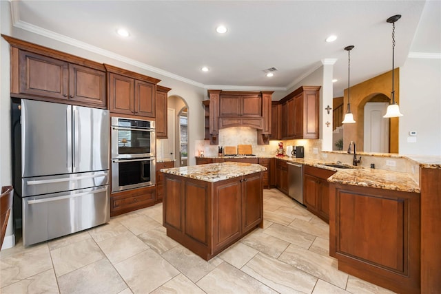 kitchen with stainless steel appliances, arched walkways, a sink, and decorative backsplash