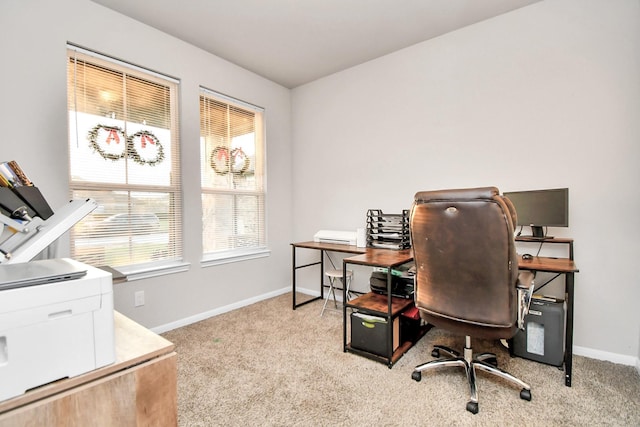 office area featuring light carpet and baseboards