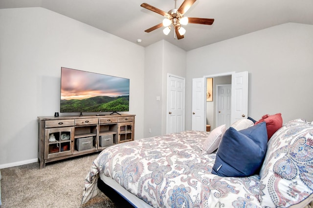 bedroom featuring carpet floors, vaulted ceiling, baseboards, and ceiling fan