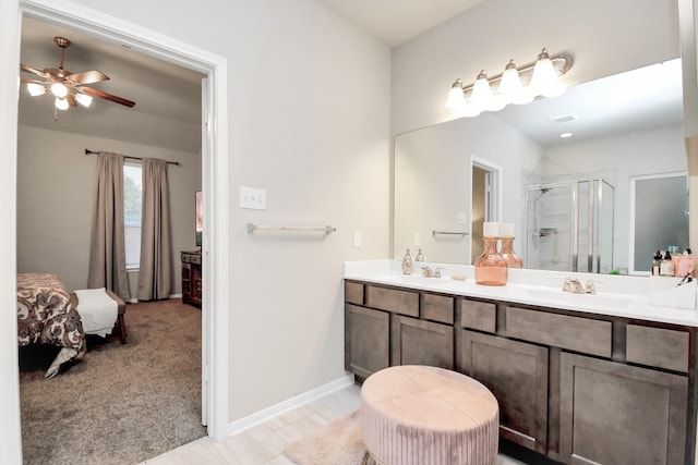 ensuite bathroom featuring ensuite bathroom, a sink, visible vents, double vanity, and a stall shower