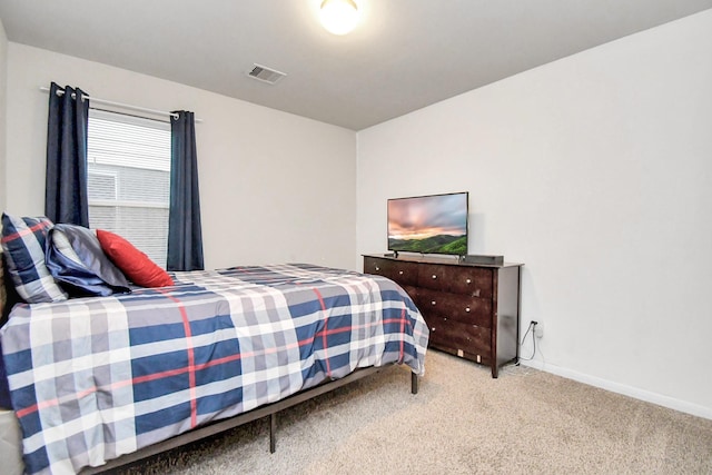 bedroom with baseboards, visible vents, and carpet flooring