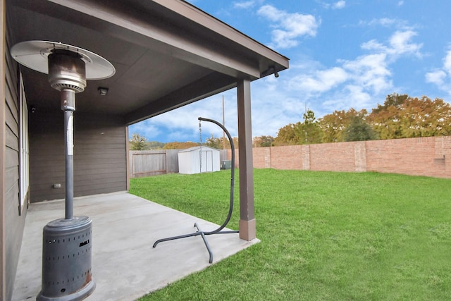 view of yard with a storage shed, a patio area, an outbuilding, and a fenced backyard