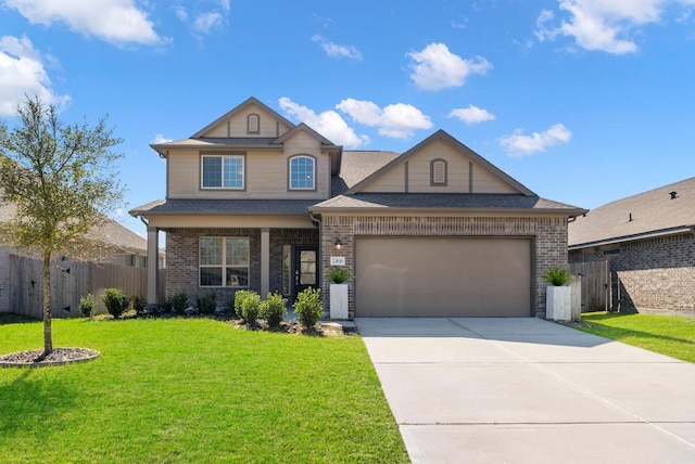 traditional-style house featuring a garage, fence, driveway, and a front lawn