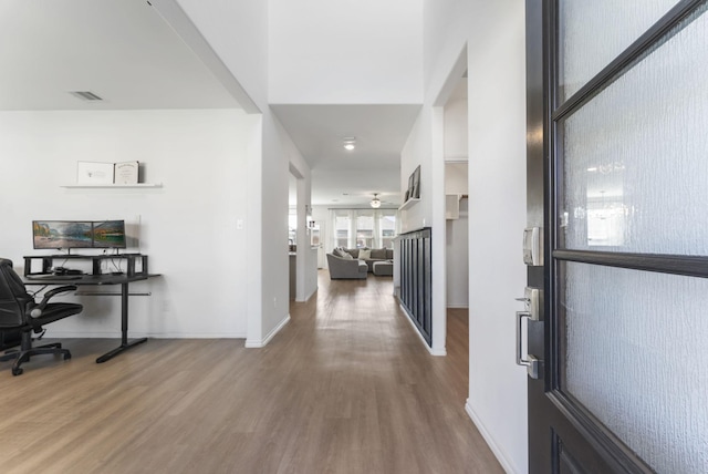 interior space featuring visible vents, baseboards, and wood finished floors