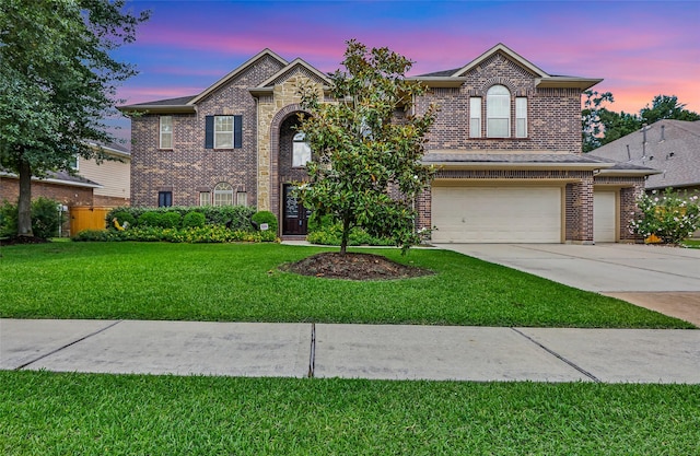 13006 Freemont Peak Ln, Humble, TX 77346 - traditional-style house with brick siding, a lawn, concrete driveway, and an attached garage