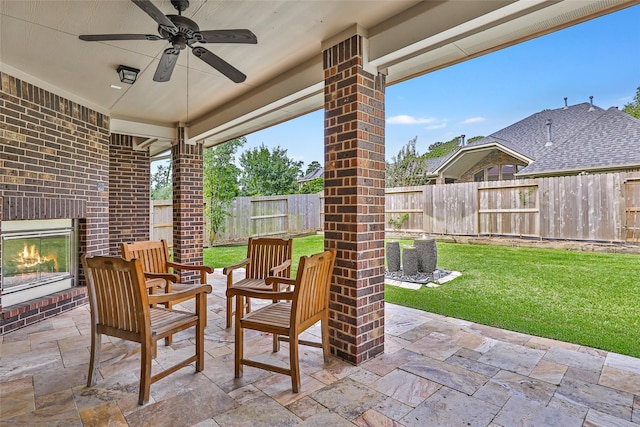 13006 Freemont Peak Ln, Humble, TX 77346 - view of patio featuring an outdoor brick fireplace and a ceiling fan
