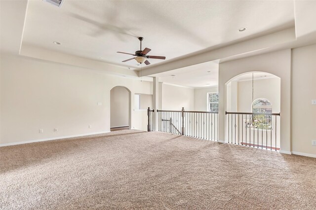 13006 Freemont Peak Ln, Humble, TX 77346 - unfurnished room with ceiling fan, carpet flooring, arched walkways, and baseboards