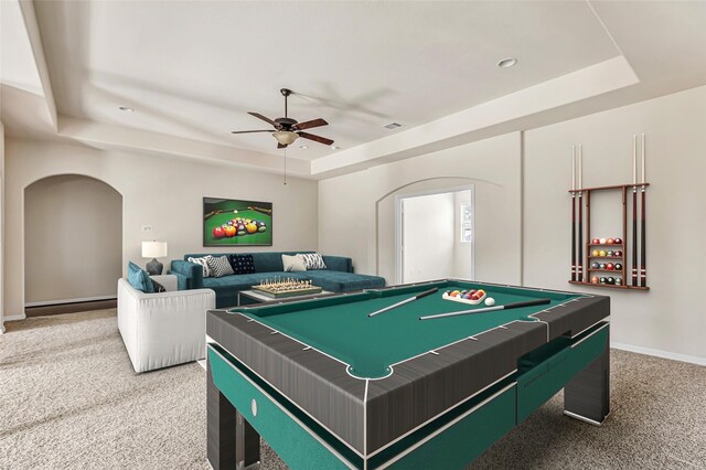 13006 Freemont Peak Ln, Humble, TX 77346 - game room with a raised ceiling, light colored carpet, ceiling fan, arched walkways, and baseboards