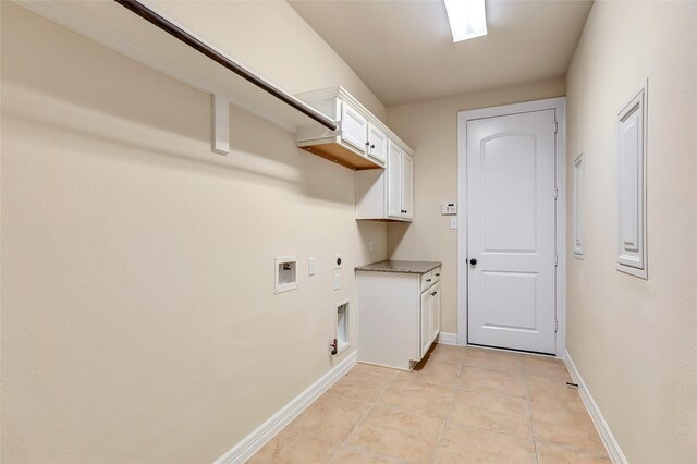 13006 Freemont Peak Ln, Humble, TX 77346 - washroom with electric dryer hookup, cabinet space, light tile patterned floors, washer hookup, and baseboards