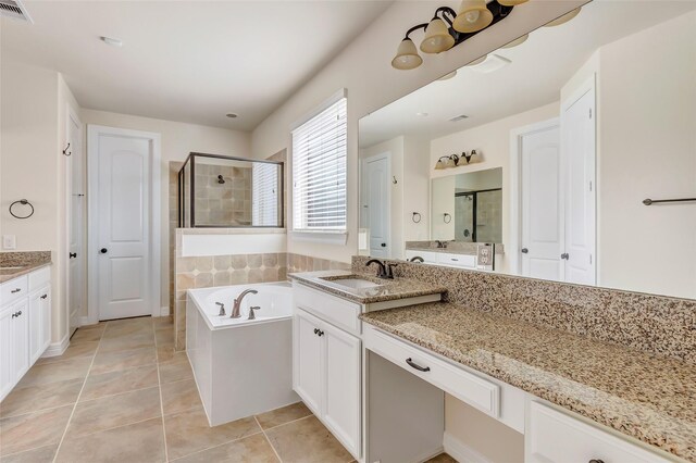 13006 Freemont Peak Ln, Humble, TX 77346 - full bathroom featuring a stall shower, two vanities, a bath, and tile patterned flooring