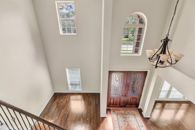 13006 Freemont Peak Ln, Humble, TX 77346 - entryway featuring wood finished floors, a high ceiling, a chandelier, and baseboards