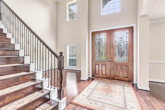 13006 Freemont Peak Ln, Humble, TX 77346 - foyer with stairway, a towering ceiling, dark wood-type flooring, baseboards, and ornamental molding