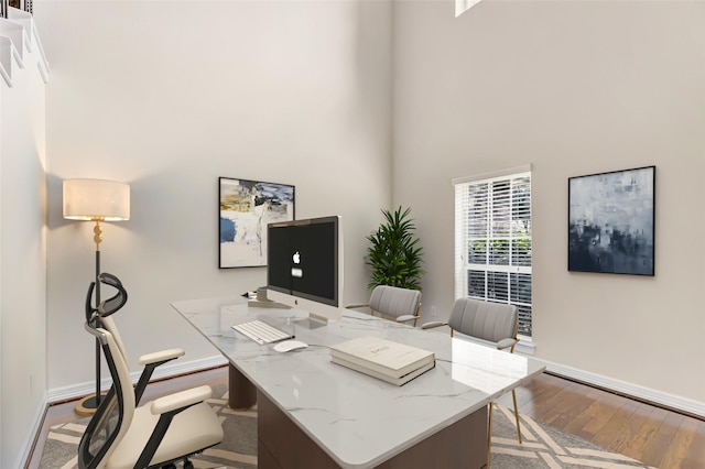 13006 Freemont Peak Ln, Humble, TX 77346 - office area with wood finished floors, a high ceiling, and baseboards
