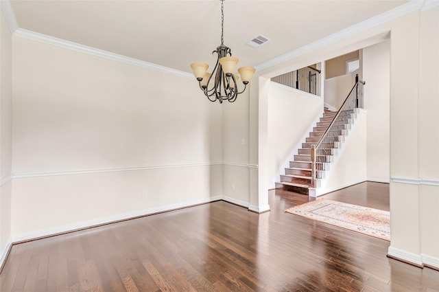 13006 Freemont Peak Ln, Humble, TX 77346 - unfurnished dining area featuring a chandelier, ornamental molding, wood finished floors, stairs, and baseboards
