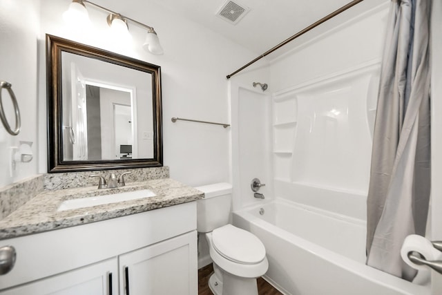 bathroom with visible vents, toilet, shower / bath combo with shower curtain, vanity, and wood finished floors