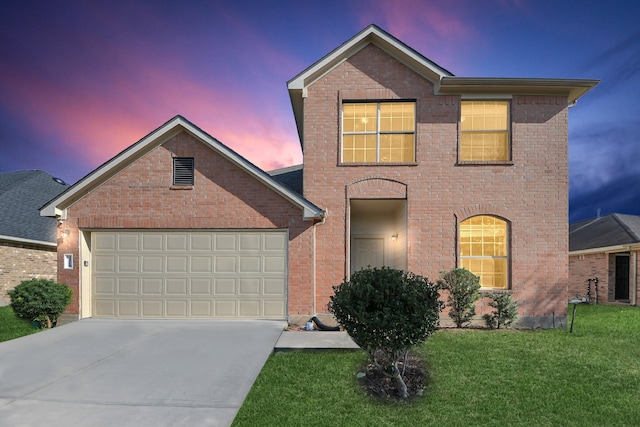 traditional-style home featuring driveway, an attached garage, a front lawn, and brick siding