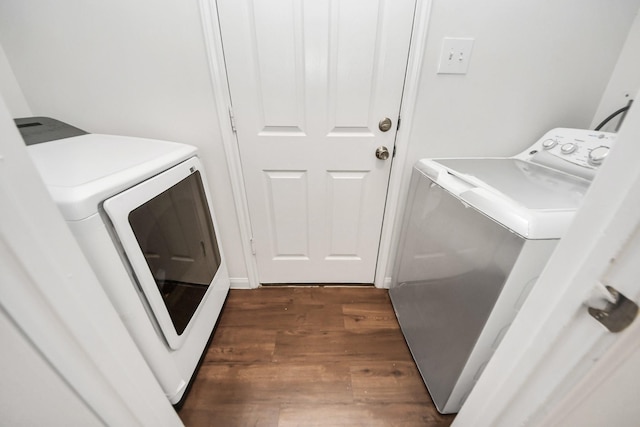 washroom with laundry area, dark wood-type flooring, and washing machine and dryer