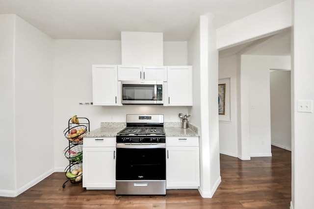 kitchen featuring light stone counters, appliances with stainless steel finishes, dark wood-style flooring, and white cabinetry