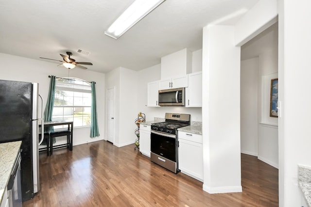 kitchen featuring stainless steel appliances, visible vents, dark wood-type flooring, white cabinets, and light stone countertops