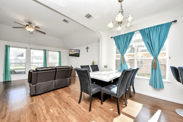 dining area with visible vents, plenty of natural light, and wood finished floors