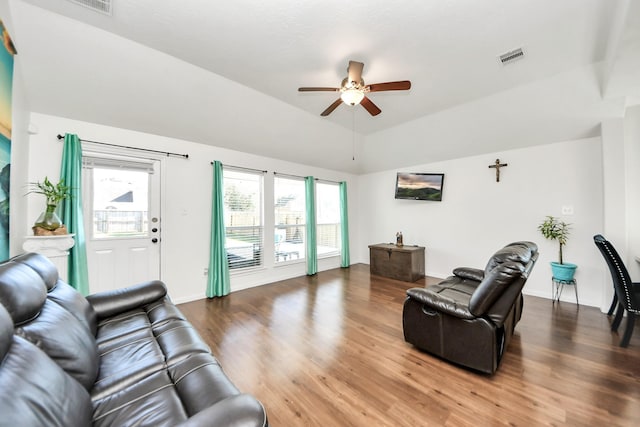 living area featuring visible vents, wood finished floors, a ceiling fan, and lofted ceiling