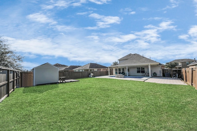 view of yard featuring a storage shed, a patio, an outdoor structure, and a fenced backyard