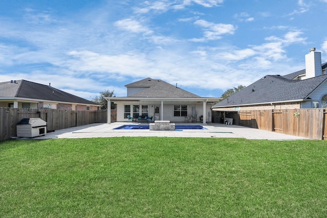 back of property featuring a yard, a patio area, and a fenced backyard