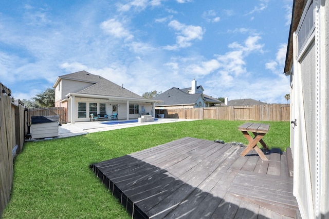 exterior space featuring a patio area, a fenced backyard, a yard, and a deck