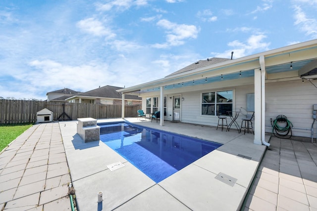 view of swimming pool featuring a patio area, a fenced backyard, and a fenced in pool