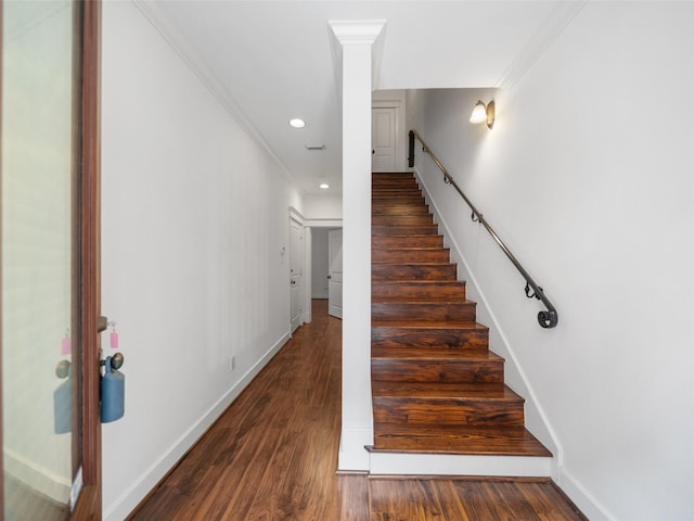 stairway with ornamental molding, recessed lighting, wood finished floors, and baseboards