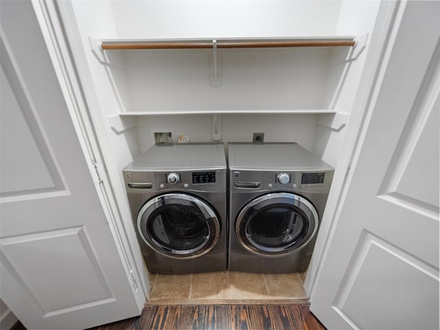 laundry room with laundry area, dark wood-style flooring, and washing machine and clothes dryer