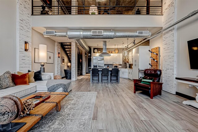 505 Bastrop St Unit 508, Houston, TX 77003 - living area with a towering ceiling, stairs, and light wood-type flooring