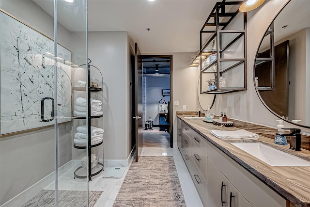 505 Bastrop St Unit 508, Houston, TX 77003 - bathroom featuring double vanity, a shower stall, baseboards, and ensuite bathroom